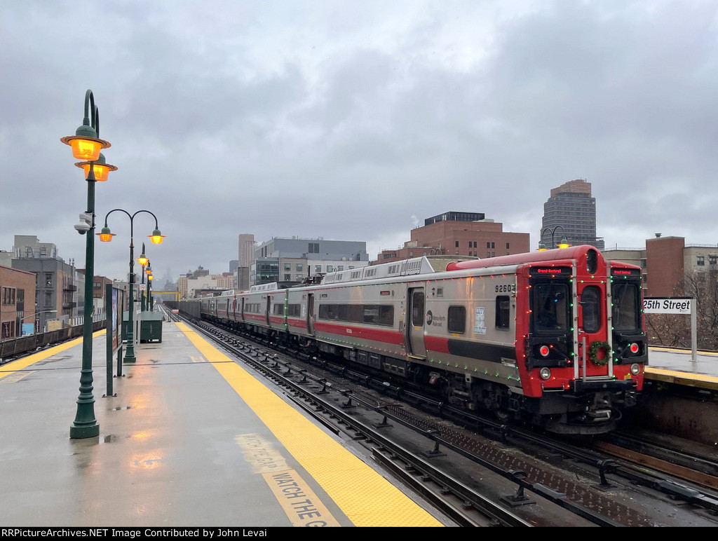 The Holiday Lights M8 Set heads away from Harlem 125th Street Station with Car # 9260 trailing